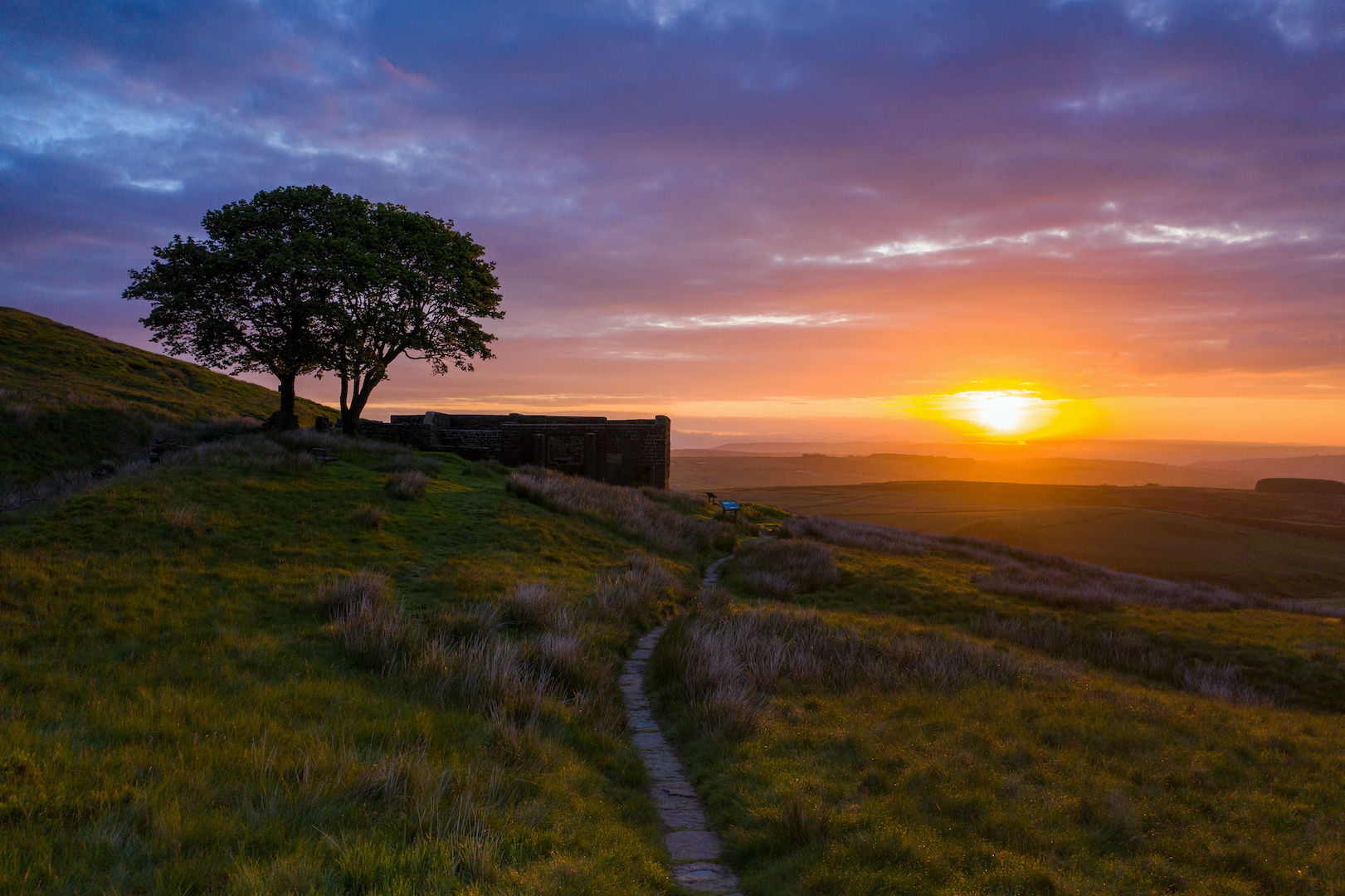 An aerial Sunrise drone shot of Top Withens; Haworth, West Yorkshire, UK